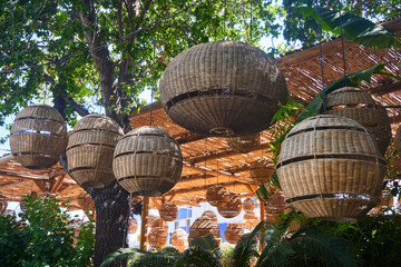 The decor of street lighting. Lamps with rattan lampshade