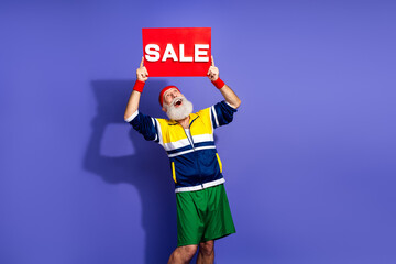 Cheerful man in retro sportswear holding a sale sign, representing lively spirit and nostalgia