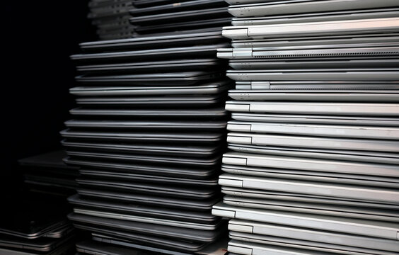 Electronic waste and e-waste - stack of laptops to be discarded