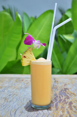 Fresh Pineapple Juice Shake Smoothie frappe in glass cup serve to customer guest travelers eat...