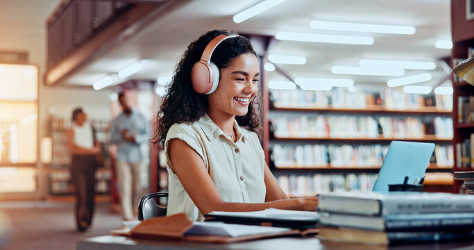 Woman, headphones and laptop in library for university, student and studying for education or project. Happy person, notes and academy campus with online video, research and assignment for knowledge