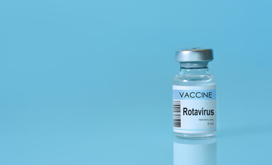 Rotavirus vaccine bottle placed on a clean blue background, symbolizing disease prevention, immunization, medical research, and public healthcare awareness. Banner format with copy space
