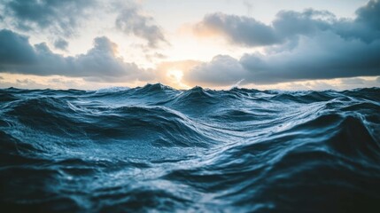 Ocean displays turbulent waves, sea blends into cloudy sky at horizon, creating moody, powerful seascape.