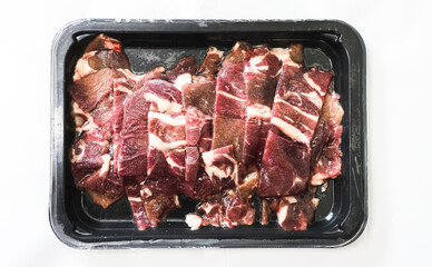 Fresh Raw Beef Cuts in Packaging Ready for Cooking or Grilling on a Neutral Background