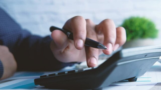 Financial hand calculating with pen