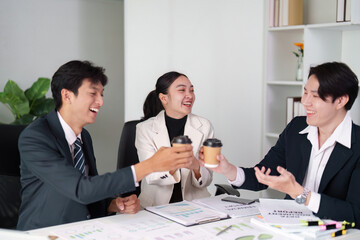 Business team celebrating success with coffee in meeting
