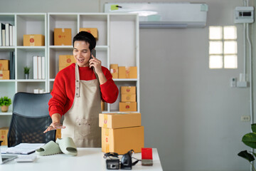 Small business owner packaging products and checking inventory