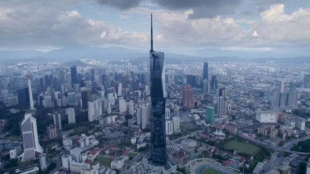 Panorama of Kuala Lumpur, Malaysia on a sunny day. Aerial circular drone view of Merdeka 118 tower megastructure