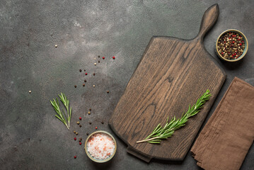 Culinary backdrop with empty wooden cutting board mockup, linen napkin, rosemary, pink himalayan...