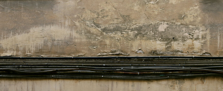 Electrical cables on the background of an old wall