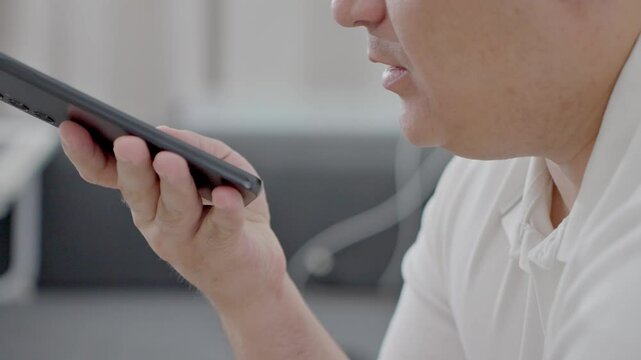 man holding iPhone with chat application WhatsApp on the screen, using mobile application for voice messaging at home. High quality photo. High quality 4k footage