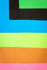 Multi color background from a paper of different colors. Abstract colorful vibrant paper textures.