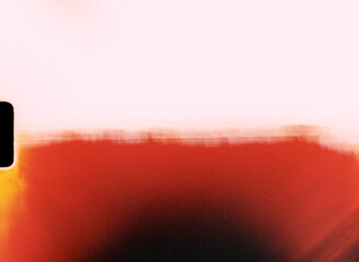 Light leak creating red gradient on damaged film material with sprocket hole