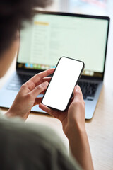 Over shoulder view of African woman student holding mobile phone with white mock up cellular screen applications working elearning using smartphone. Cellphone display mock up for advertising. Vertical