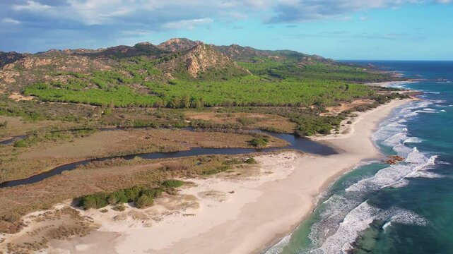Aerial drone view on white sand Berchida beach of Sardegna. Warm turquoise sea and long beach on the Sardinia island.