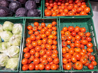 Fresh Organic Tomatoes and Cabbage in Grocery Store Baskets