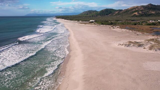 Aerial drone view on white sand Berchida beach of Sardegna. Warm turquoise sea and long beach on the Sardinia island.
