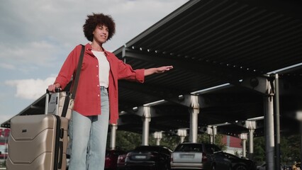 Female ready to travel with luggage, waiting taxi.