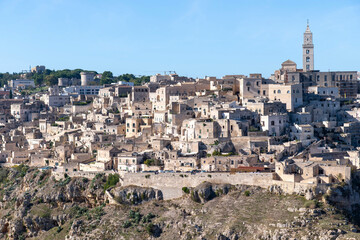 Panoramic view cliffs with buildings on the Gravina di Matera of Matera, Italy, know for the Sassi or Ancient town with its rock-cut urban core and twin cliffside zones, collectively the Sassi