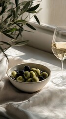 An olive bowl on the table, with fresh green olives