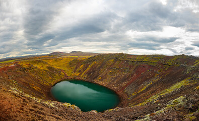 Volcanic crater Kerid with blue lake inside, at autumn day, Iceland Gold Circle tourist attraction.
