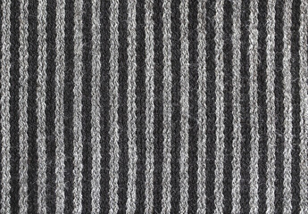 A striped wool knitted fabric closeup in grey