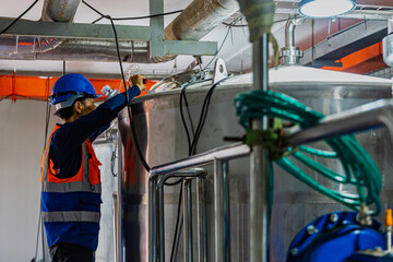 Male work inspection process stainless steel pipe stainless with pressure meter in equipment tank...