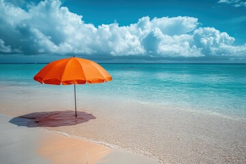 Fototapeta premium Bright orange umbrella on sandy beach by the clear blue ocean Generative AI