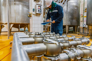 Male work inspection process stainless steel pipe stainless with pressure meter in equipment tank facility for drink cellar at the with vertical stainless valve