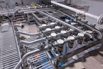 Stainless vertical steel tanks and pipes with pressure meter in equipment tank chemical cellar at the with stainless steel tanks