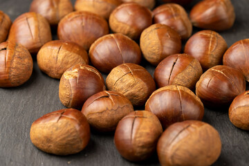 a cross incised on a chestnut shell edible chestnut fruits for frying or baking
