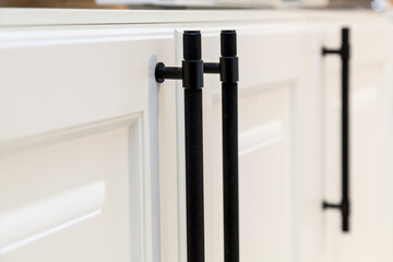 Modern black kitchen cabinet handles on white doors