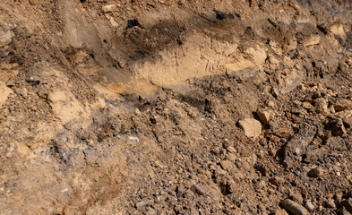 the end of summer at the construction site, dry sand and earth in sunny weather, side view