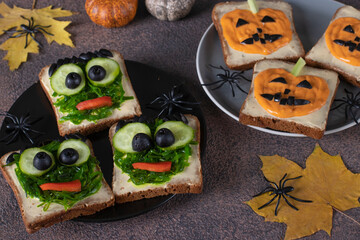 Sandwiches with green monsters and scary pumpkins for Halloween party
