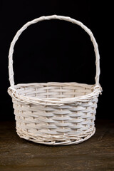 a white basket for food or other items, natural branches painted white from which a decorative...