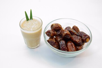 Glass of Sweet Date Smoothie and Bowl of Fresh Dates on White Surface
