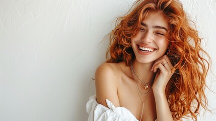 Naklejka premium Joyful woman laughing with smartphone in hand captured in portrait photography studio setting
