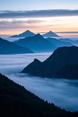 mountains covered in fog and low clouds at sunset