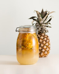 Fermented pineapple beverage tepache, mexican drink, in a glass jar, selective focus