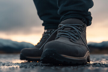 Tying shoelaces in preparation for a morning jog on a cloudy day in the outdoors