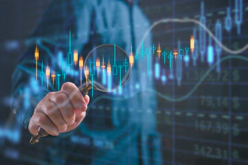 Businessman holding magnifying glass with stock chart in concept of Investment finance chart, stock market business and exchange financial growth graph