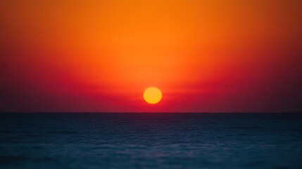 Obraz premium A vibrant sunset with its colors over the calm ocean waters