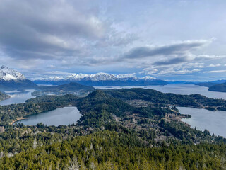 Beautiful range of snowy mountains and a lake with blue sky above in Bariloche Argentina, amazing panoramic view at Circuito Chico Patagonia.