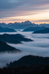 mountains covered in fog and low clouds at sunset