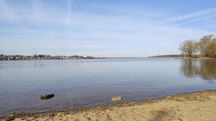 Volga River coast in early spring. Russia, Kostroma. Wide, calm river with mirrored surface