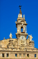 Fototapeta premium Baroque clocktower church with statues in Valencia