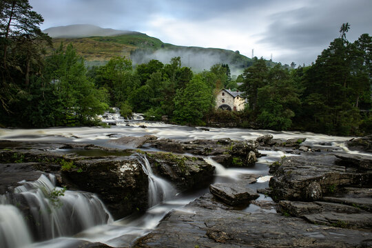 Rushing, white water rapids of the Falls of Dochart in the town of Killin, Perthshire, central Scotish highlands.