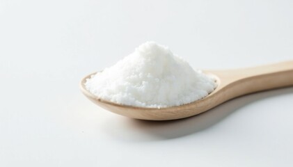 Spoonful of white sugar against white backdrop, pure, macro