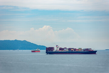 Cargo container ship sailing near Singapore. She is starting voyage on her international trade...