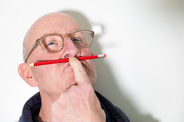 Stockholm, Sweden A man stands with a red pencil in his lips.